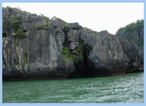 [b]ภาพที่ 4 [/b]ภาพชั้นหินของเกาะเขาใหญ่ ด้านล่างจะเป็นชะง่อนหิน ในลักษณะเชิงผา-ถ้ำ พายเรือเล็กๆลัดเ